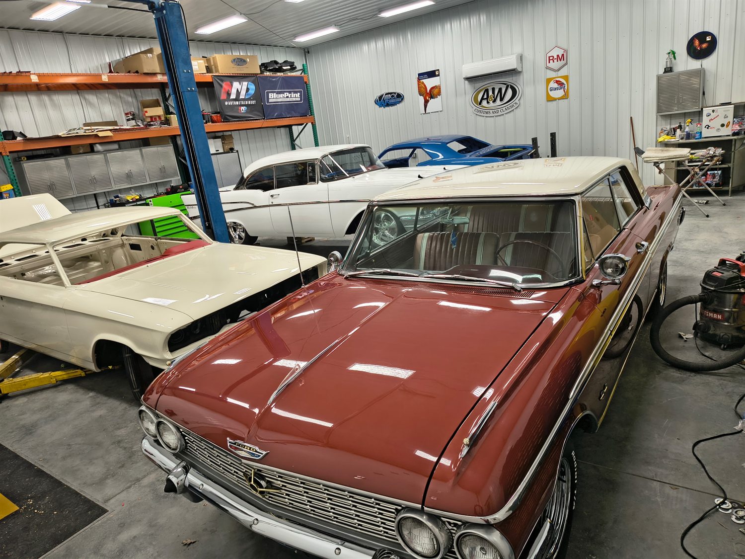 Classic vehicles inside the A&W shop