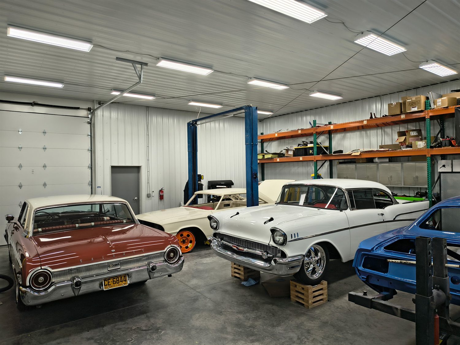 Classic vehicles lined up inside the A&W shop